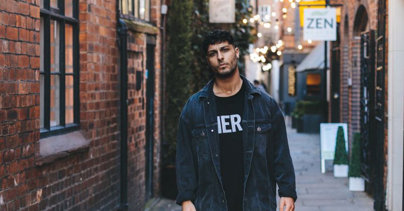 Styles - Man Wearing Jacket Standing Near Wall