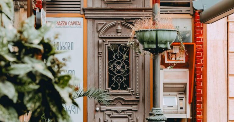 Styles - A photo of a building with a door and a plant